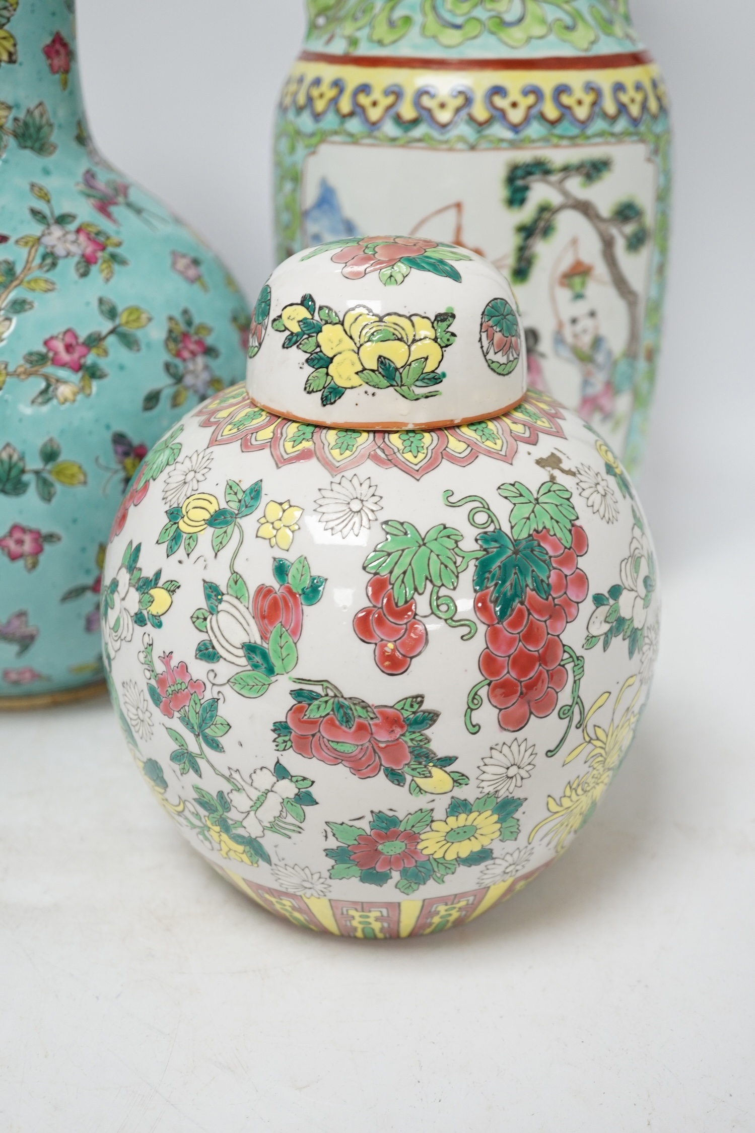 Two 20th century Chinese famille rose vases and a similar jar and cover, tallest 40cm. Condition - good